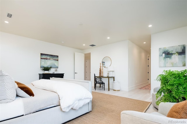 bedroom featuring light wood-type flooring, visible vents, and recessed lighting