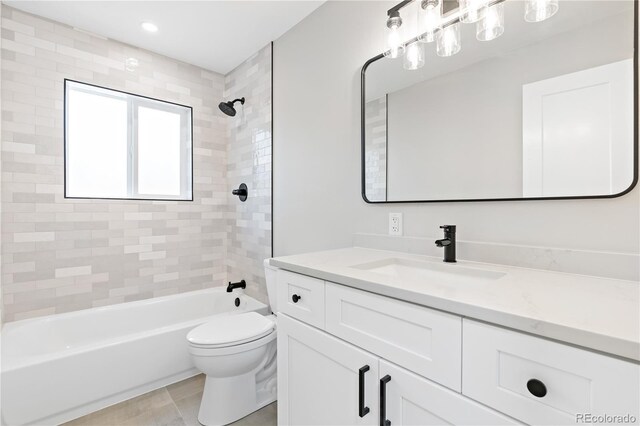 full bathroom with vanity, tiled shower / bath combo, toilet, and tile patterned floors