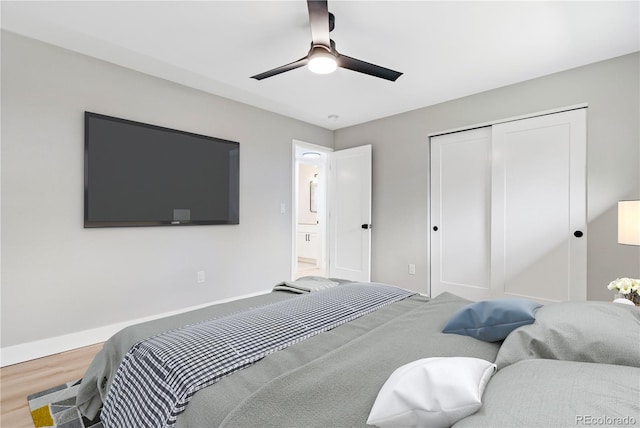 bedroom featuring hardwood / wood-style floors, ceiling fan, and a closet