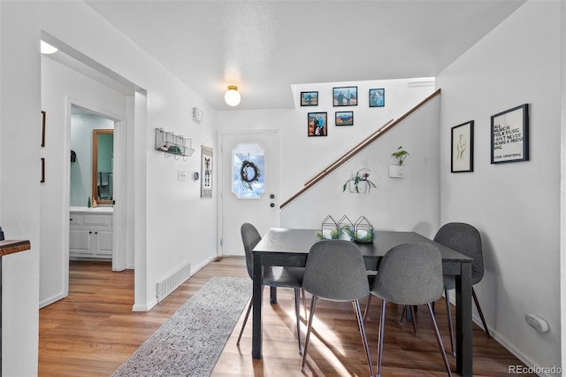 dining room featuring light wood-type flooring and sink