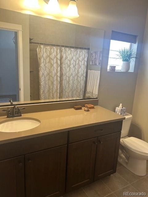 bathroom featuring vanity, curtained shower, tile patterned floors, and toilet