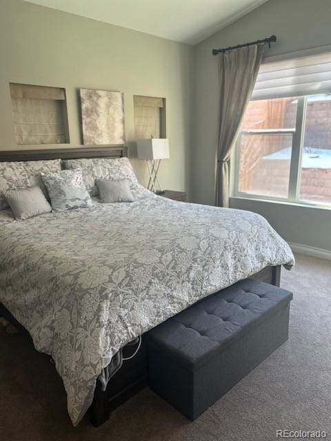 bedroom featuring vaulted ceiling and carpet