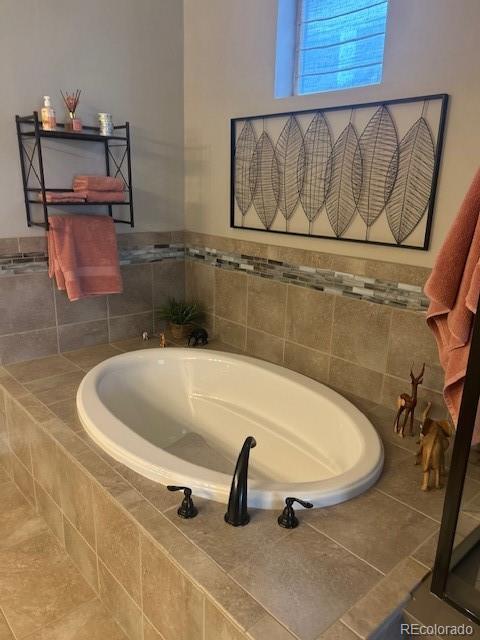 bathroom featuring tiled bath