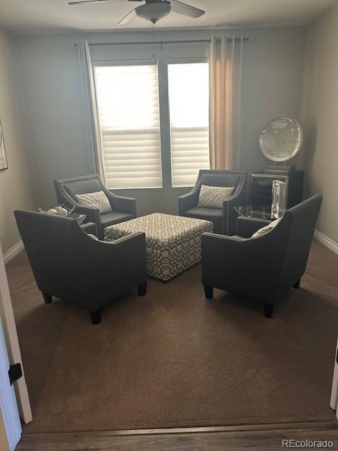 living room featuring carpet floors and ceiling fan