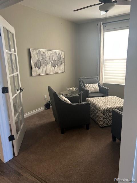 interior space featuring ceiling fan, dark carpet, and french doors