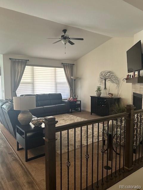 living room featuring hardwood / wood-style floors and ceiling fan