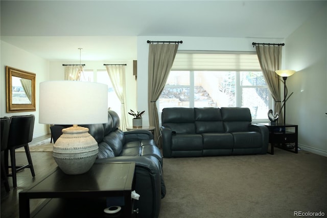 carpeted living area with a wealth of natural light and baseboards