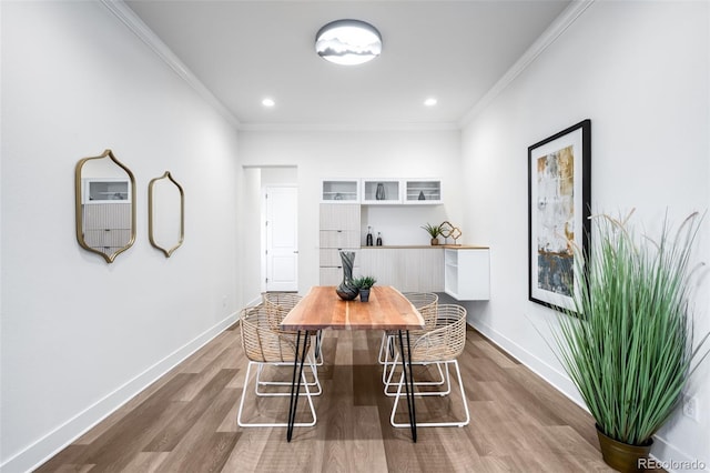 16262 W 95th Ln, Arvada, CO 80007 - dining space with dark wood-style flooring, ornamental molding, and recessed lighting