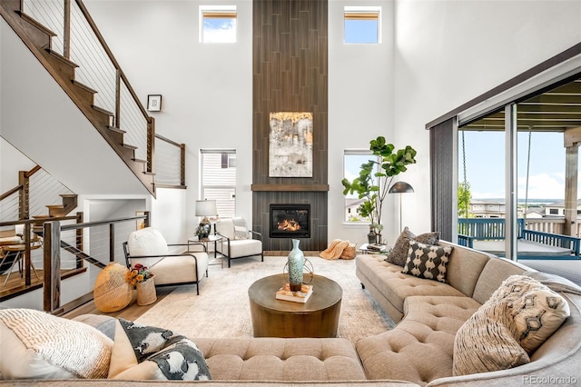 16262 W 95th Ln, Arvada, CO 80007 - living area with a high ceiling, a fireplace, and stairway