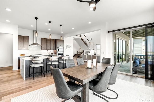 16262 W 95th Ln, Arvada, CO 80007 - dining space featuring light wood finished floors, stairs, recessed lighting, and a ceiling fan