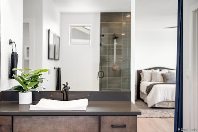 16262 W 95th Ln, Arvada, CO 80007 - bathroom with vanity, a stall shower, wood finished floors, and ensuite bathroom