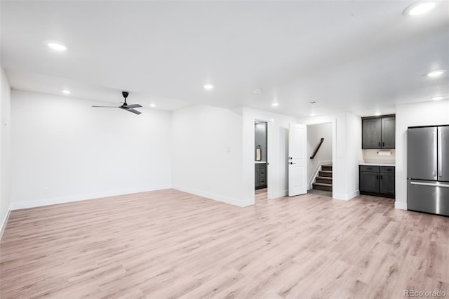 16262 W 95th Ln, Arvada, CO 80007 - unfurnished living room featuring stairway, light wood-style floors, recessed lighting, and a ceiling fan