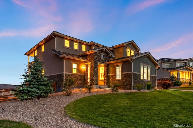 16262 W 95th Ln, Arvada, CO 80007 - view of front of house featuring stone siding, stucco siding, and a lawn
