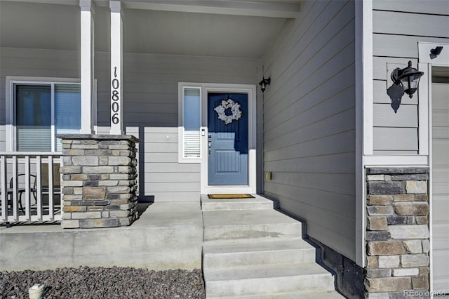 view of exterior entry featuring a porch