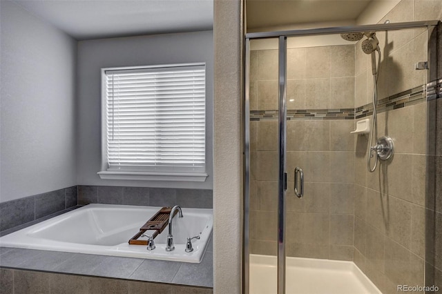 bathroom featuring separate shower and tub