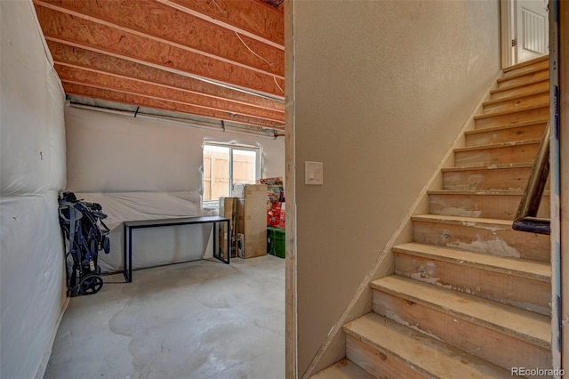 stairway featuring concrete flooring