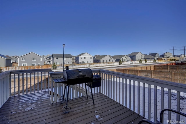 wooden terrace featuring a grill