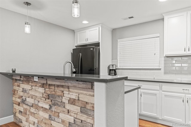 15021 Josephine St, Thornton, CO 80602 - kitchen with freestanding refrigerator, white cabinetry, dark countertops, recessed lighting, and decorative light fixtures
