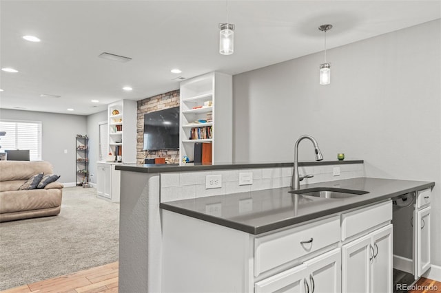 15021 Josephine St, Thornton, CO 80602 - kitchen featuring dark countertops, open floor plan, light wood-type flooring, white cabinetry, and recessed lighting