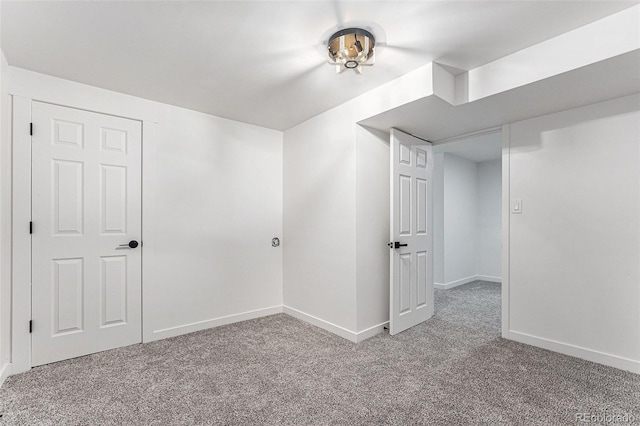 interior space featuring carpet flooring and baseboards