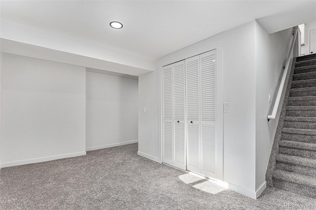 below grade area with baseboards, stairway, recessed lighting, and carpet