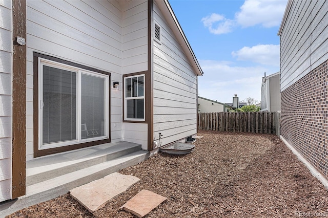 view of side of home with fence
