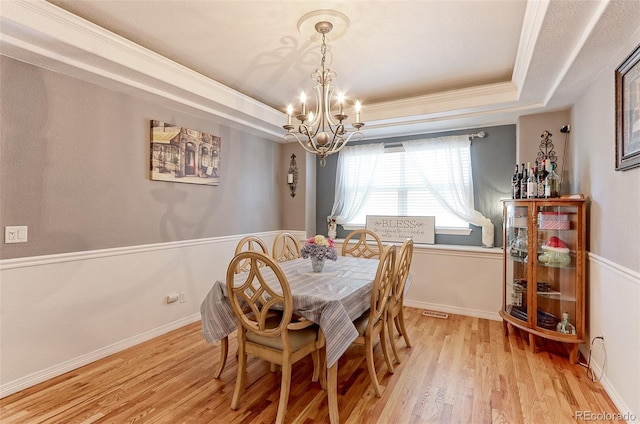 9994 Quintero St, Commerce City, CO 80022 - dining area with a chandelier, light wood-type flooring, a tray ceiling, crown molding, and baseboards