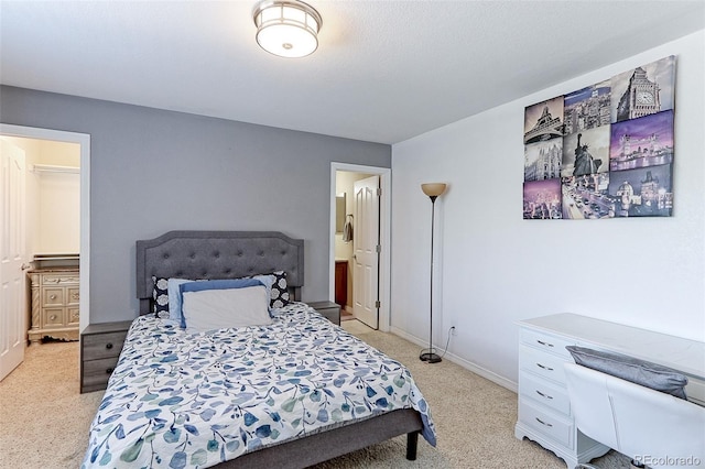 9994 Quintero St, Commerce City, CO 80022 - bedroom featuring light carpet, ensuite bathroom, and baseboards