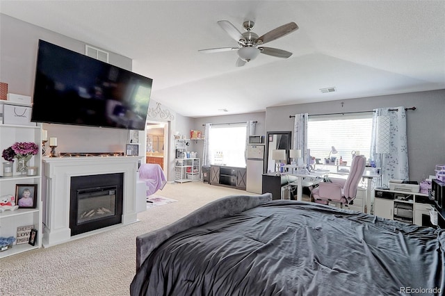 9994 Quintero St, Commerce City, CO 80022 - bedroom with carpet flooring, a glass covered fireplace, lofted ceiling, and a ceiling fan