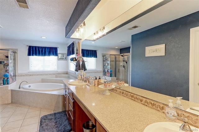 9994 Quintero St, Commerce City, CO 80022 - bathroom with a stall shower, tile patterned flooring, a bath, double vanity, and a textured ceiling