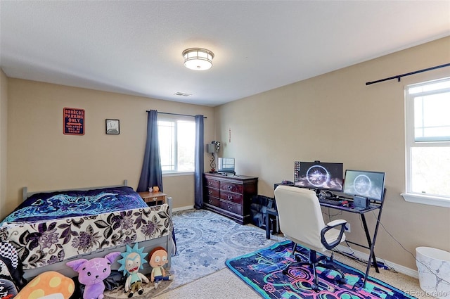 9994 Quintero St, Commerce City, CO 80022 - carpeted bedroom featuring multiple windows and baseboards