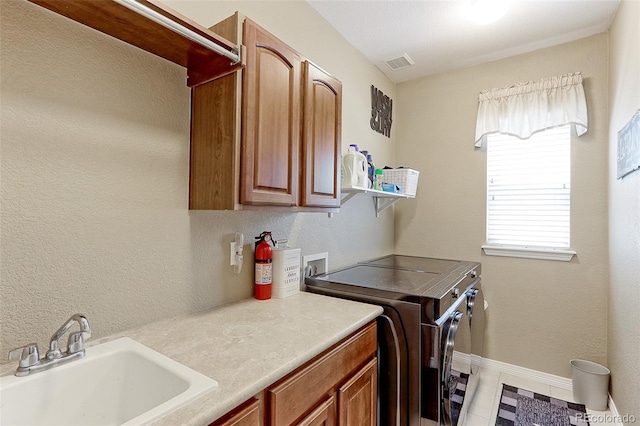 9994 Quintero St, Commerce City, CO 80022 - washroom with cabinet space, plenty of natural light, washing machine and dryer, and baseboards