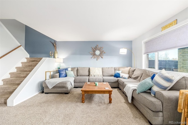 living room featuring carpet floors and stairway