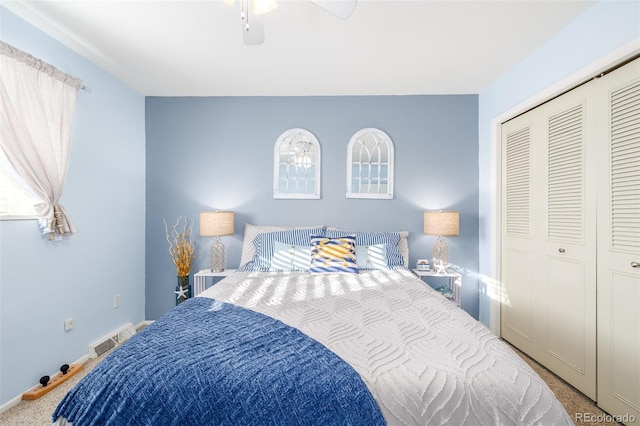 bedroom with ceiling fan, visible vents, baseboards, a closet, and carpet