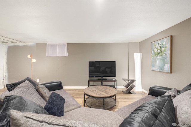 living room featuring baseboards and wood finished floors