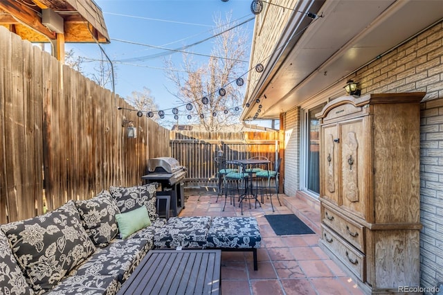 view of patio / terrace featuring outdoor dining space, a grill, and fence