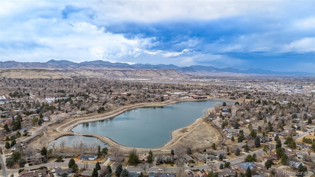 drone / aerial view featuring a water and mountain view