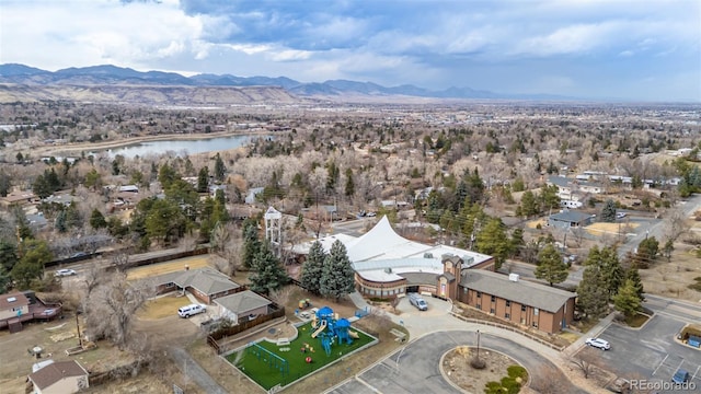 drone / aerial view featuring a water and mountain view