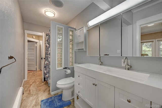 4642 Plettner Ln, Evergreen, CO 80439 - full bathroom with toilet, vanity, a baseboard heating unit, baseboards, and a shower with shower curtain