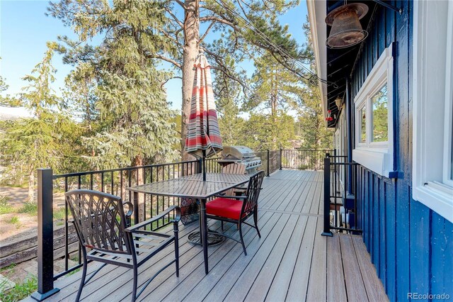 4642 Plettner Ln, Evergreen, CO 80439 - wooden deck with outdoor dining area and area for grilling