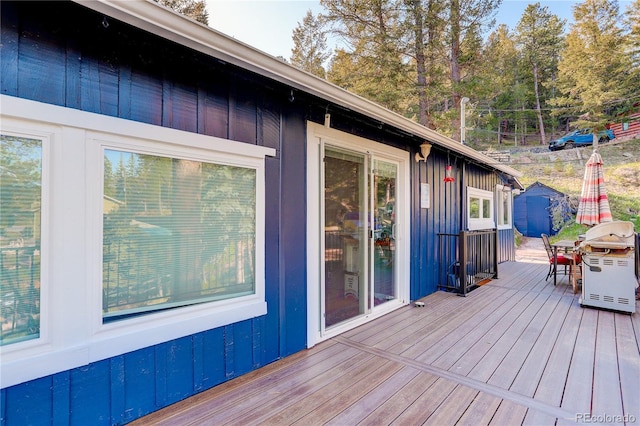 4642 Plettner Ln, Evergreen, CO 80439 - deck featuring outdoor dining area, a shed, an outbuilding, and a grill