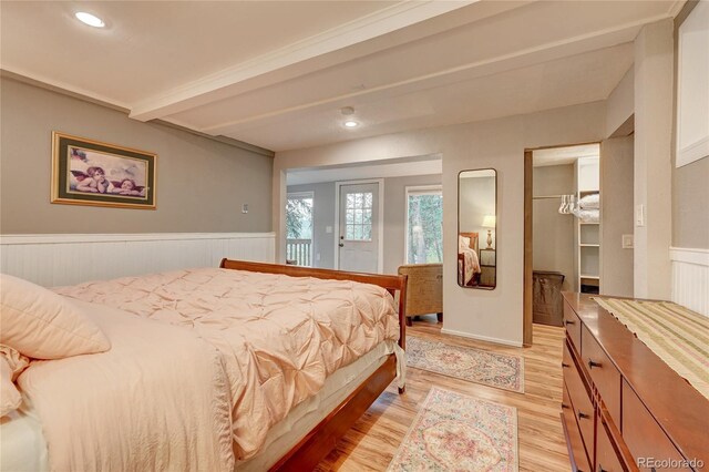 4642 Plettner Ln, Evergreen, CO 80439 - bedroom featuring light wood-style floors, wainscoting, beamed ceiling, access to outside, and recessed lighting