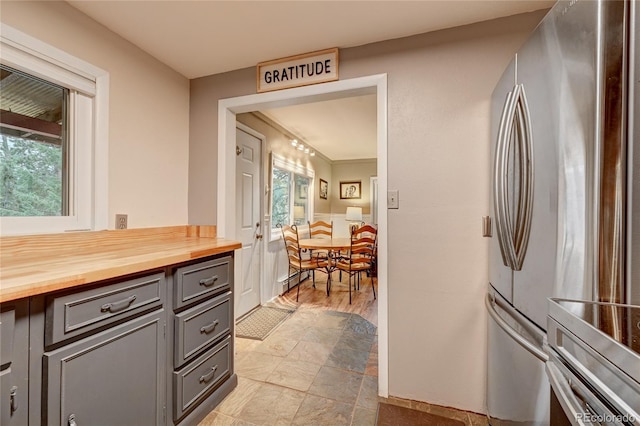 4642 Plettner Ln, Evergreen, CO 80439 - kitchen featuring freestanding refrigerator, gray cabinetry, and wooden counters