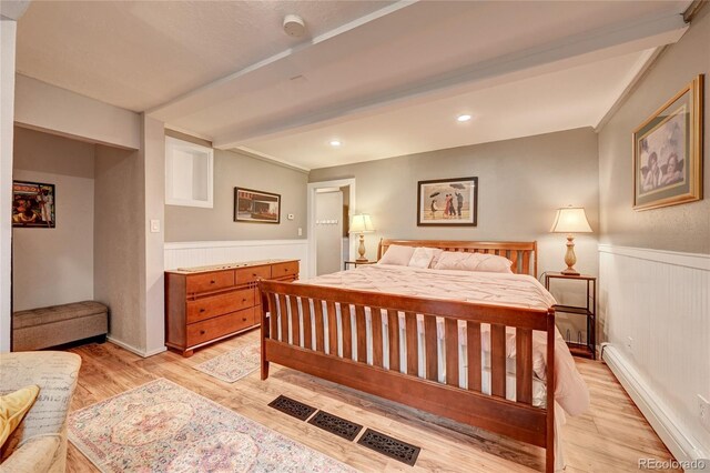 4642 Plettner Ln, Evergreen, CO 80439 - bedroom with a wainscoted wall and light wood-style flooring