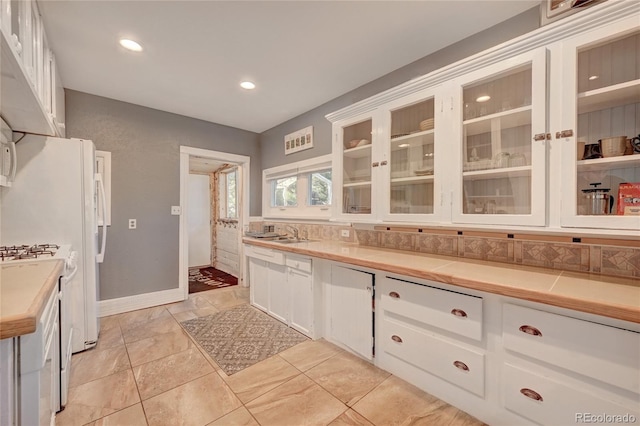 4642 Plettner Ln, Evergreen, CO 80439 - kitchen featuring white cabinetry, light countertops, glass insert cabinets, recessed lighting, and tasteful backsplash