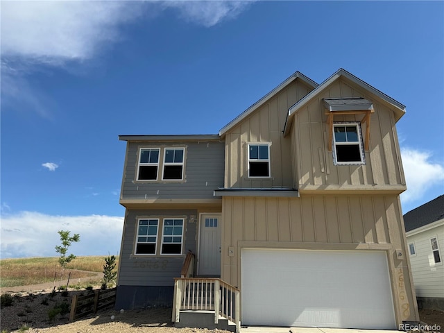16468 W 92nd Pl, Arvada, CO 80007 - view of front of property featuring board and batten siding, a garage, and driveway