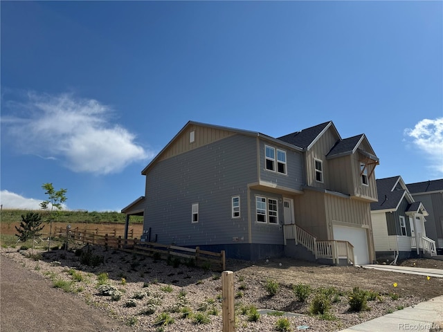 16468 W 92nd Pl, Arvada, CO 80007 - view of side of property with an attached garage and driveway