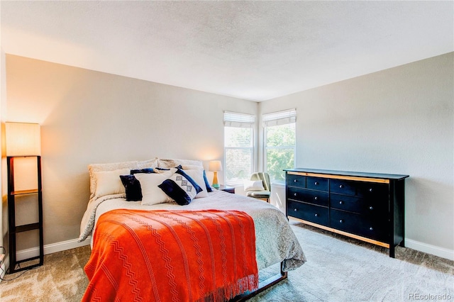 carpeted bedroom with baseboards
