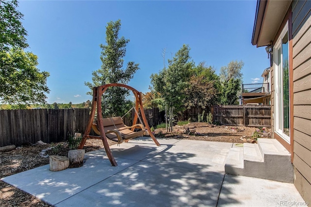 view of jungle gym featuring a fenced backyard and a patio