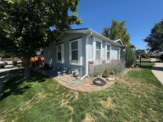 view of home's exterior with a lawn